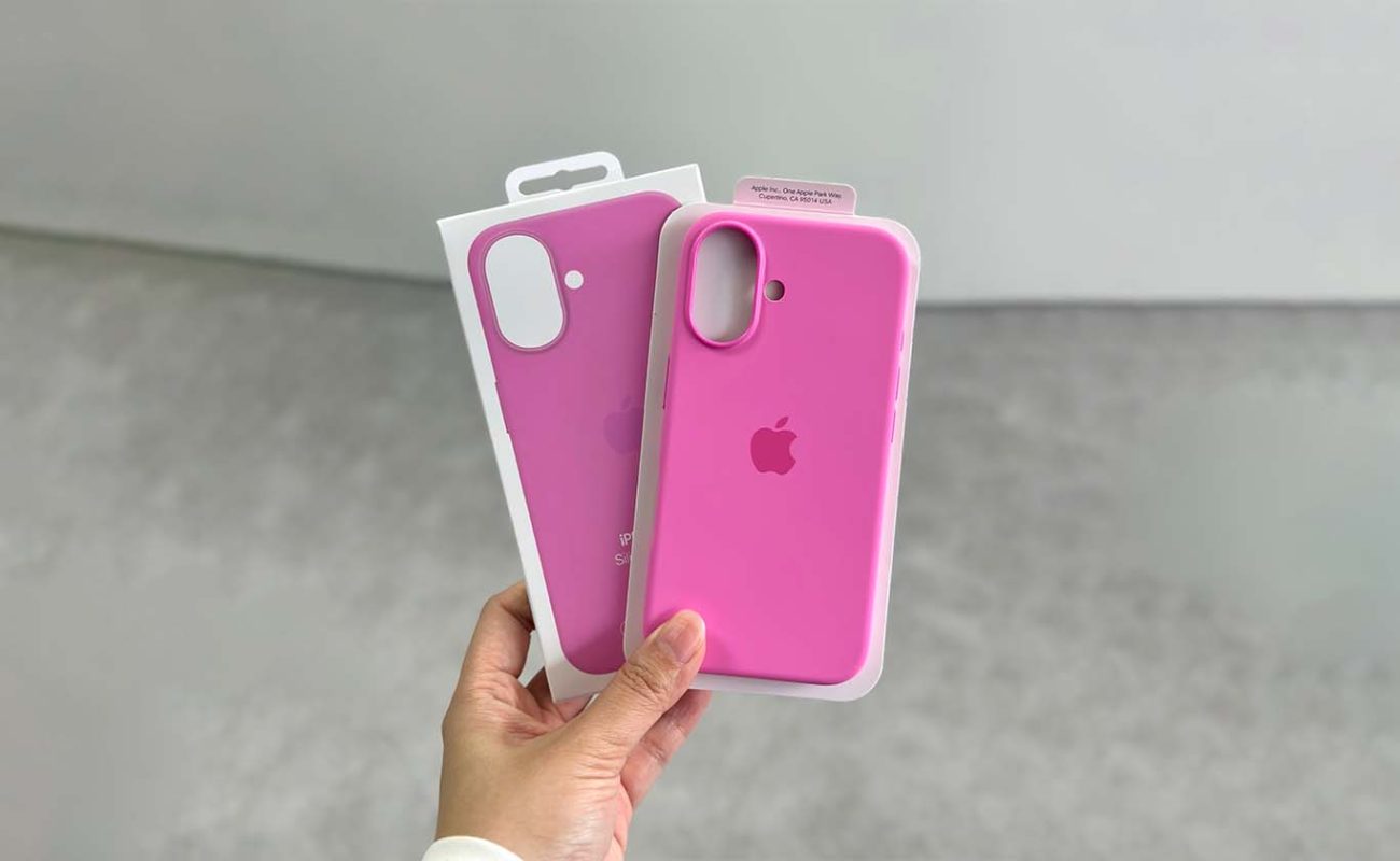 Holding the pink silicon phone case for iPhone 16