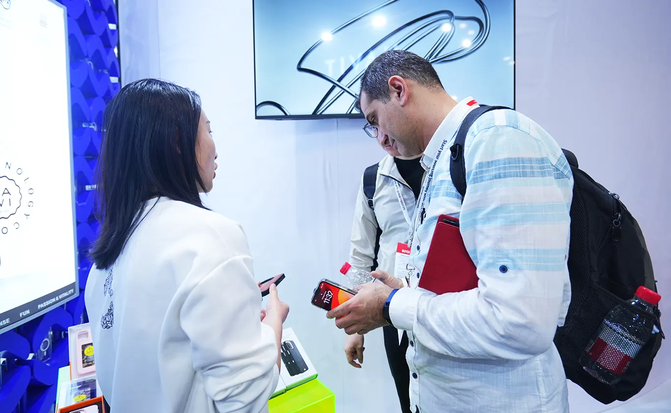 Phone case manufacturers showcasing products and discussing samples with visitors at the Hong Kong Global Sources Electronics Show